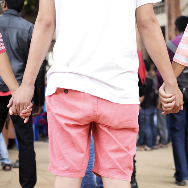 Drei junge Menschen stehen in einer Gemeinschaft zusammen und halten sich an den Händen, symbolisch für Teamgeist und Zusammenhalt während eines FSJ oder BFD bei der AWO Wiesbaden.