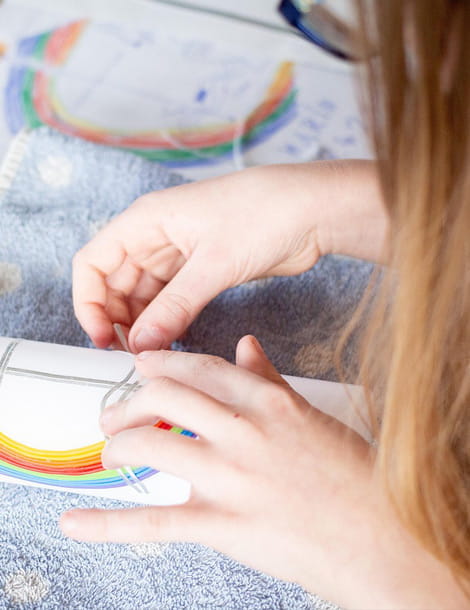 Kind gestaltet ein kreatives Bastelprojekt mit buntem Motiv im Rahmen eines Angebots der Internationalen Familienbildungsstätte Hedi Konrad in Wiesbaden